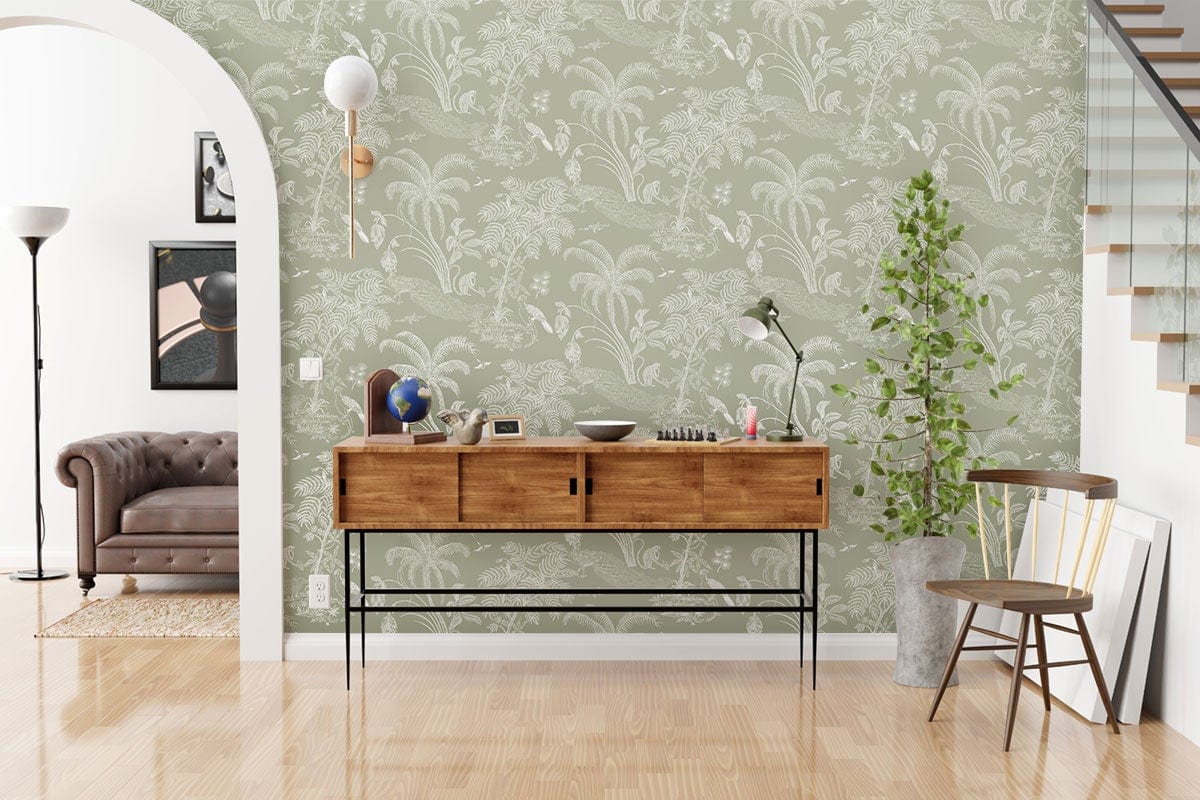 Elegant Sage Green Tropical Jungle Wallpaper in modern living room with wooden sideboard, brown sofa, and plant.