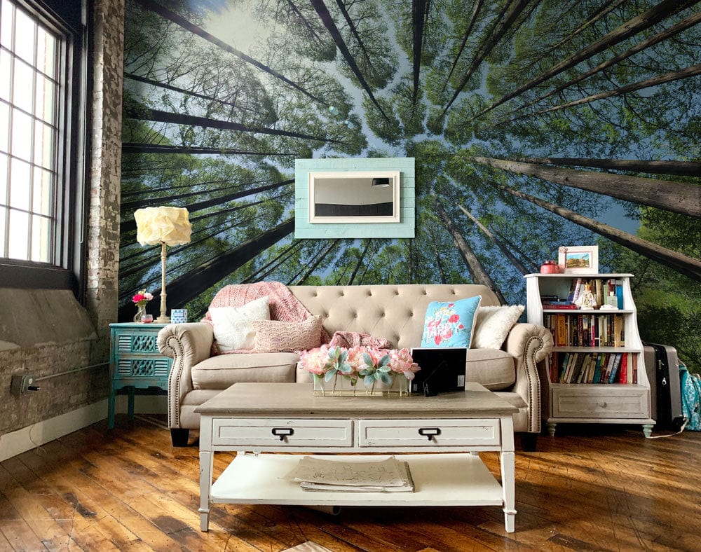 Forest Canopy Mural Wallpaper in rustic living room with beige sofa, wood flooring, and vintage decor.