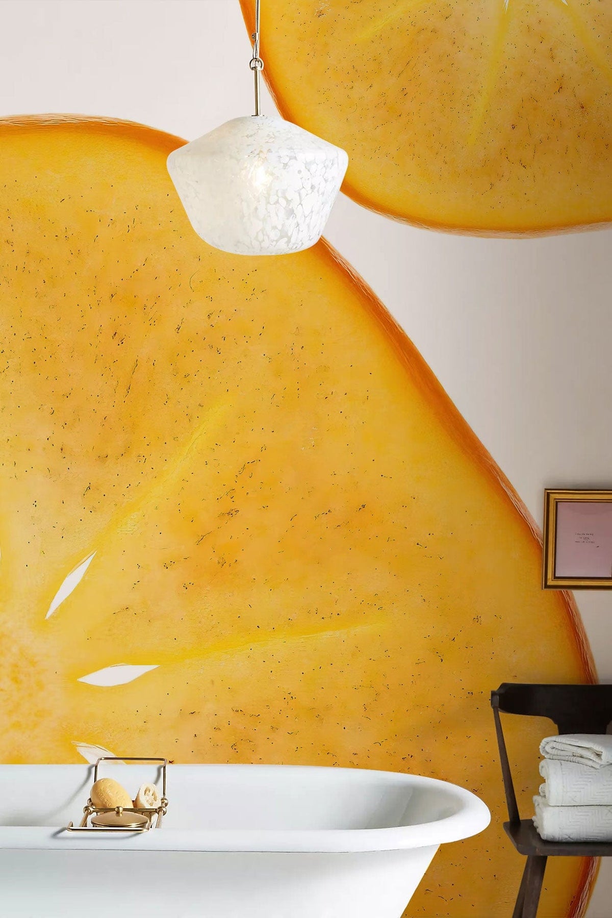 Golden persimmon wallpaper with white bath, modern pendant light, minimalistic bathroom decor, bright citrus style.