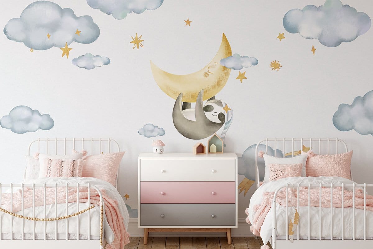 Dreamy sloth mural in nursery with pastel bedlinen, white furniture, wooden flooring, and cloud decor.