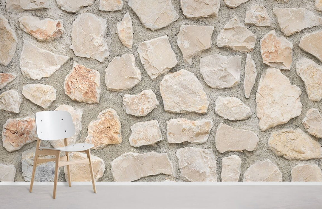Beige and grey rustic stone effect wallpaper with modern white chair on light wood flooring.