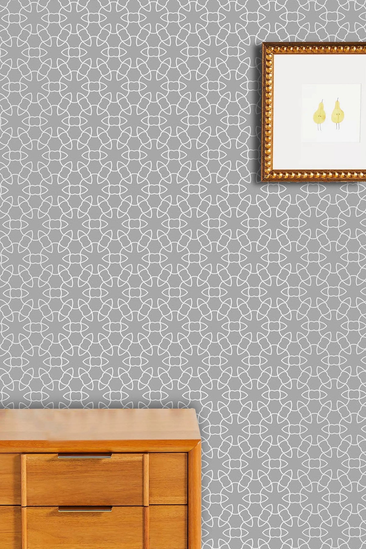 Grey geometric star wallpaper, modern interior, wooden dresser, framed artwork, elegant wall design.