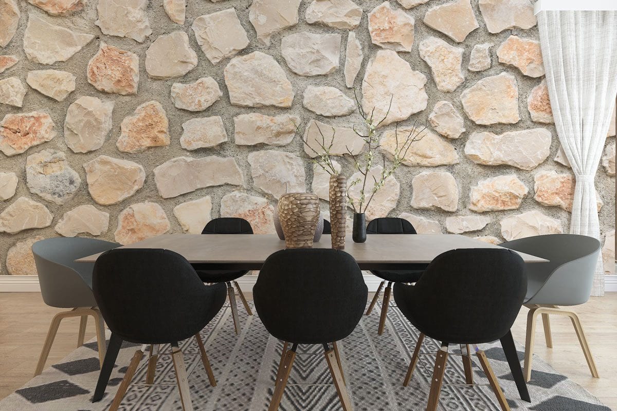 Dining area with beige-grey stone wallpaper, black chairs, wooden flooring, and geometric rug. Modern decor.