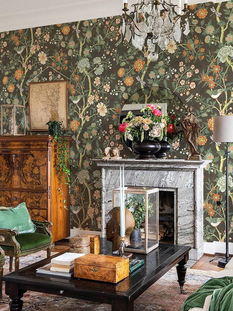 Vintage botanical floral wallpaper in dark earthy tones, Victorian style with ornate wooden cabinet, fireplace.