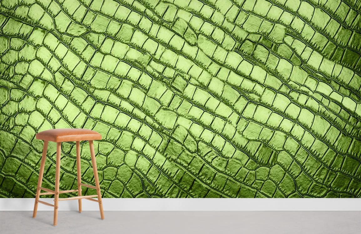 Green textured reptile-skin-effect wallpaper in a modern setting with wooden stool and grey floor.