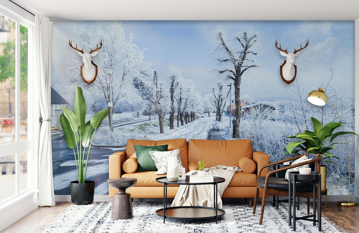 Frosty Winter Wonderland mural wallpaper with snowy scenery, tan sofa, wood flooring, living room decor.