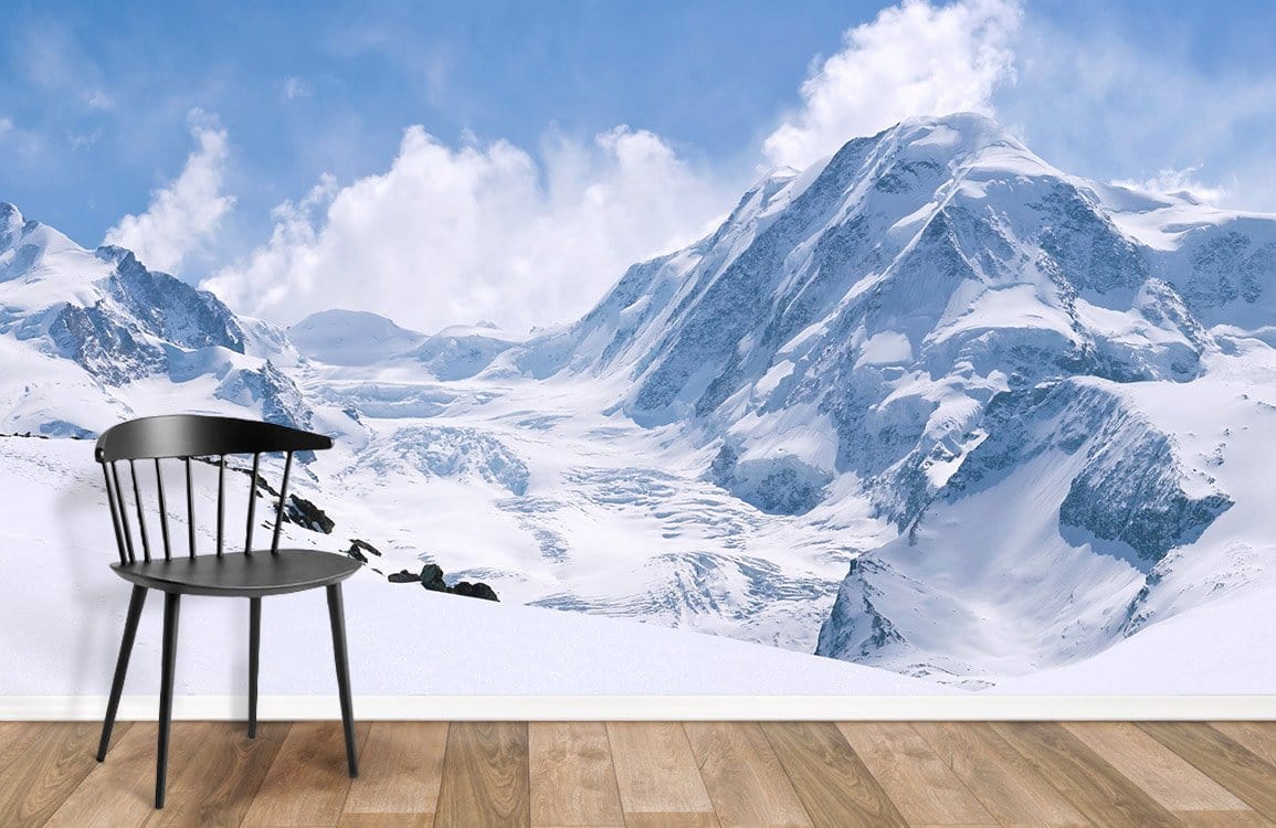 Majestic Snowy Mountain Mural Wallpaper, serene blue, wooden flooring, black chair, nature-inspired decor.