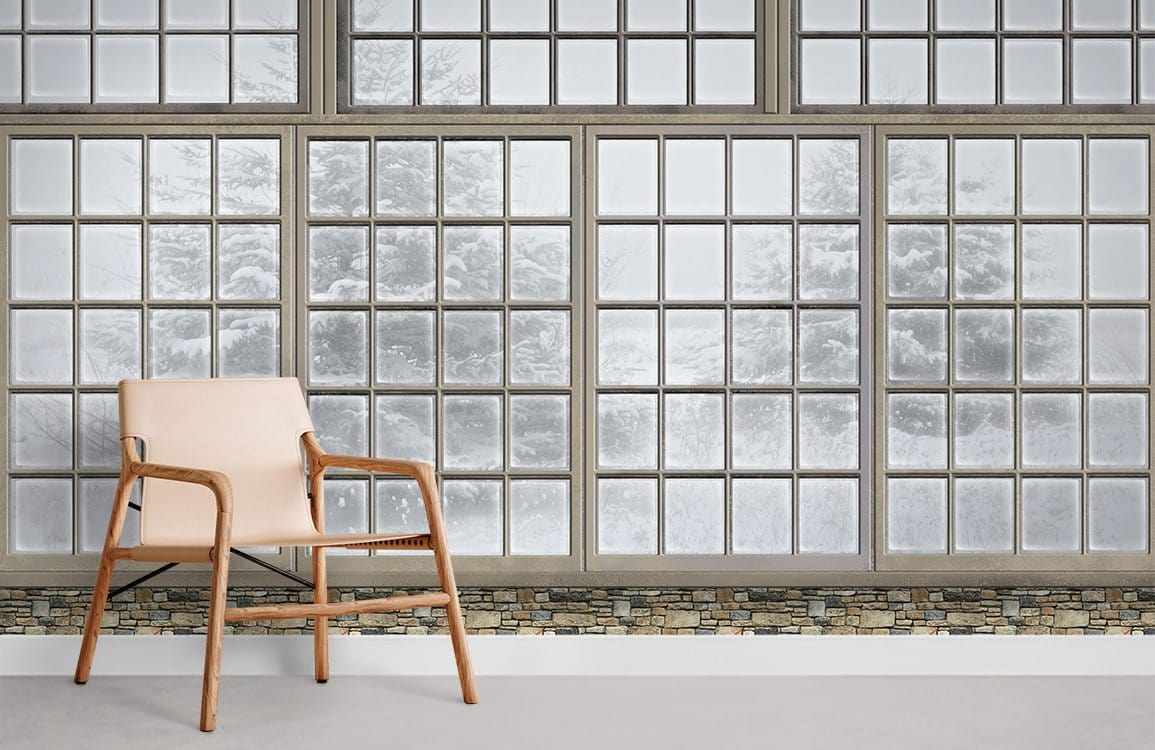Rustic Winter Window View mural wallpaper, frosted snow scene, beige chair, stone accent wall, minimalist room.