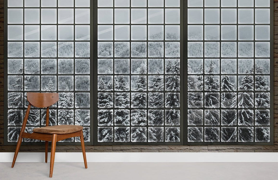 Panoramic Winter Wonderland Mural Wallpaper featuring snowy forest, wooden chair, neutral flooring, contemporary room.
