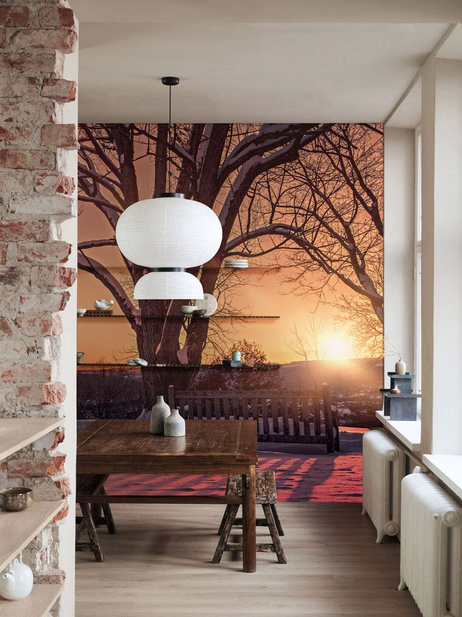 Cosy dining room with rustic table, exposed brick, Serene Winter Sunset Mural Wallpaper, warm wooden flooring.