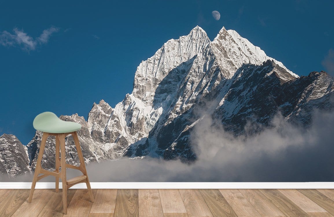 Majestic Mountain Peaks mural wallpaper, blue sky, wood flooring, modern stool in tranquil living space.