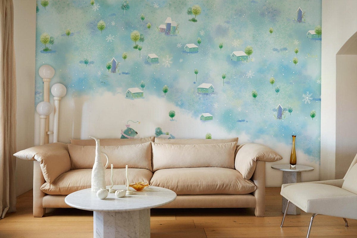 Whimsical mural wallpaper with snowy cottages, beige sofa, modern lamps, wooden flooring, marble table.