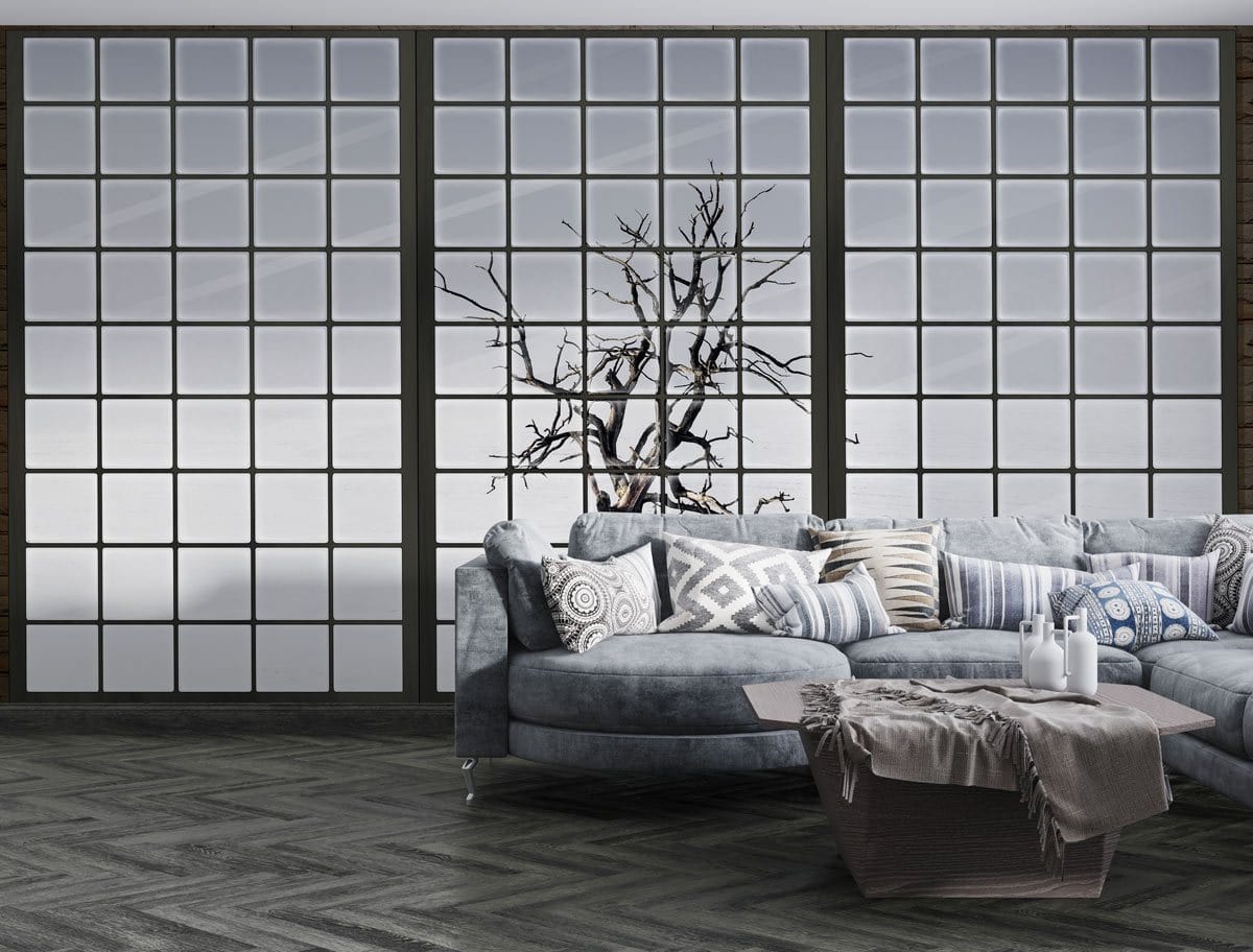 Winter Tree Black and White Mural Wallpaper, minimalist design, grey corner sofa, herringbone flooring.