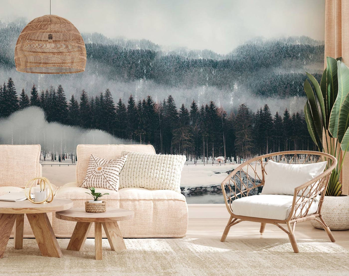 Tranquil winter forest mural in soft greys, neutral sofa, wicker chair, wooden tables, cosy living room.