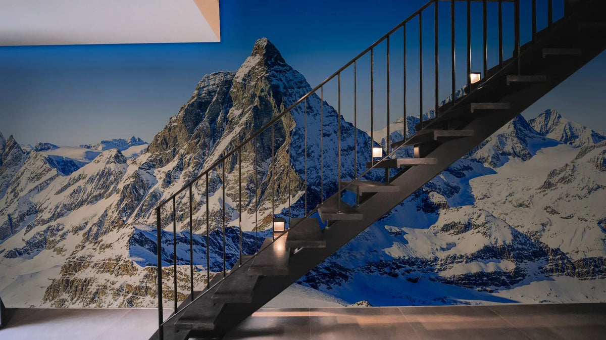 Stunning Alpine Mountain Landscape Mural Wallpaper in cool tones, with modern staircase and elegant flooring.