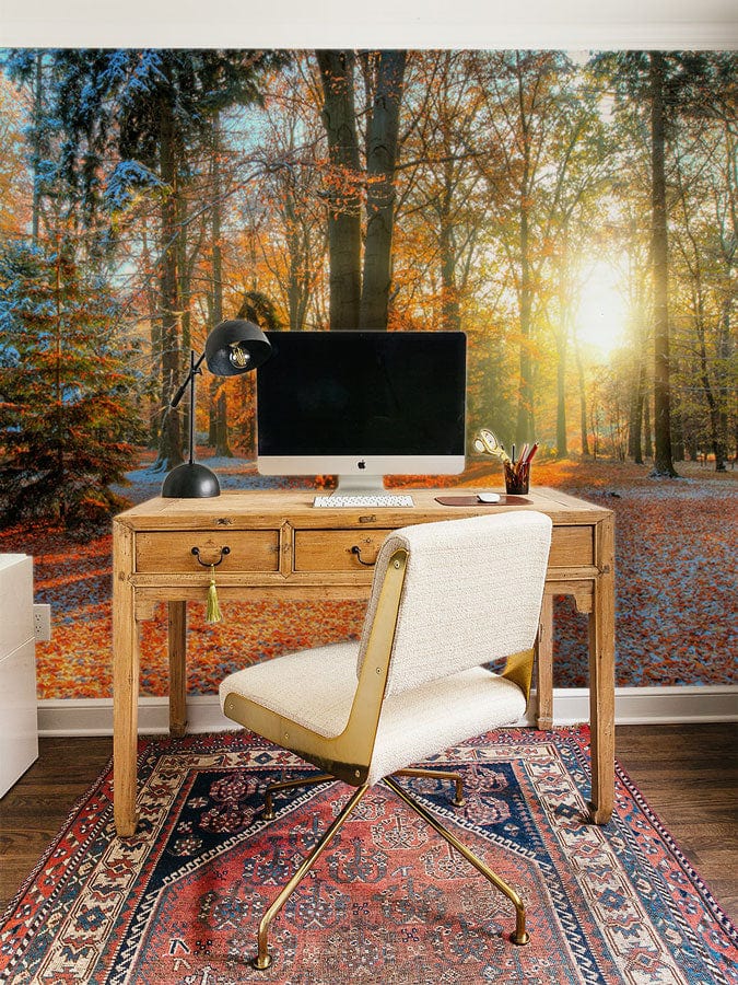 Autumn sunrise forest mural with golden leaves, vintage desk, white chair, rug in home office.
