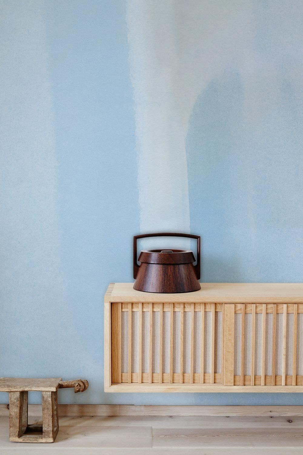Serene Sky Blue Watercolour Wallpaper; minimalist decor with light wood furniture, hardwood flooring, serene interiors.