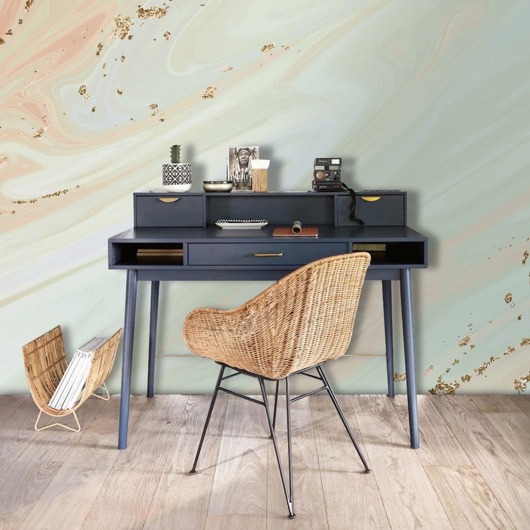 Elegant pastel swirl wallpaper, gold accents, wooden desk, rattan chair, light wooden flooring, office setting.