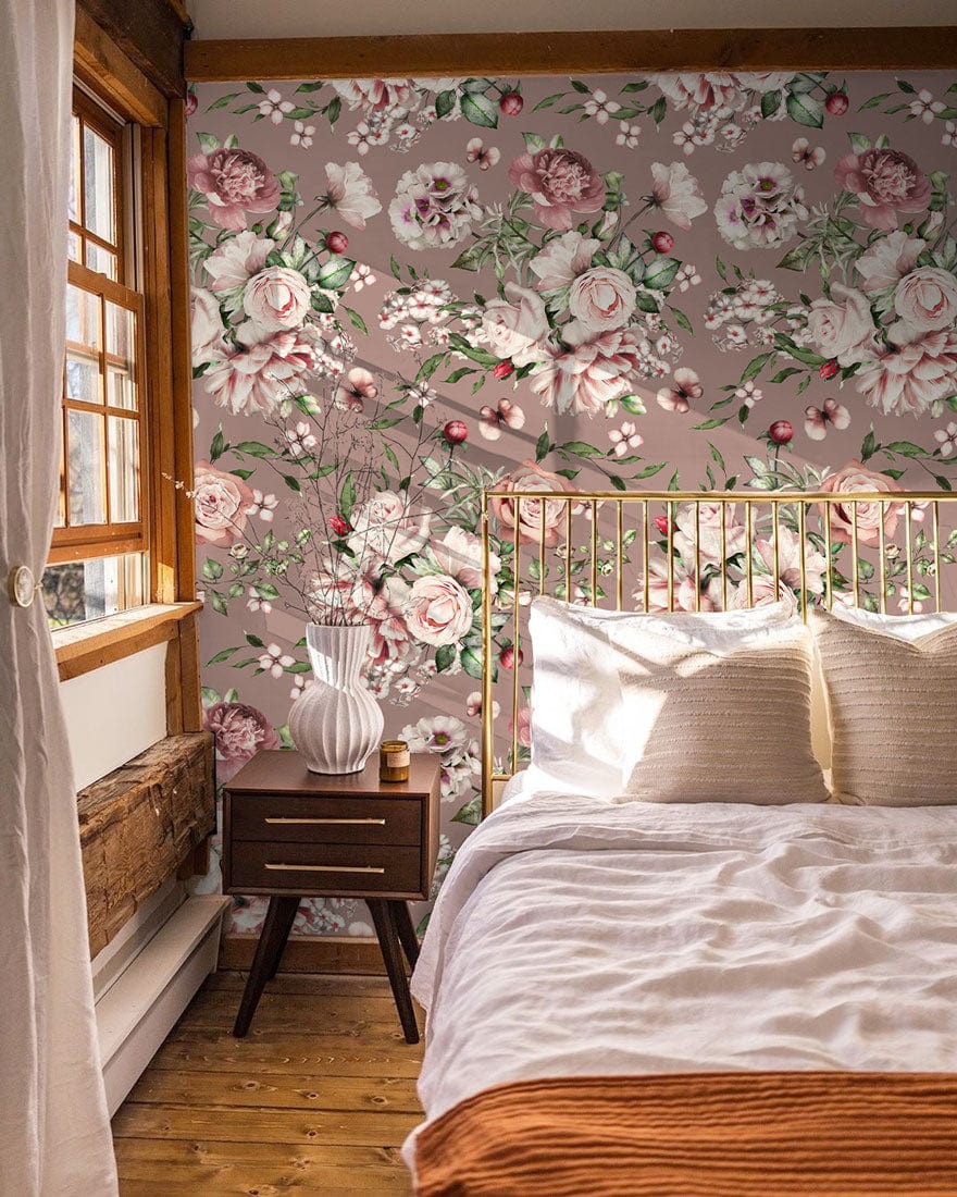 Vintage Blossom wallpaper in bedroom, soft pink-green tones, brass bedframe, wooden floor, bedside table.