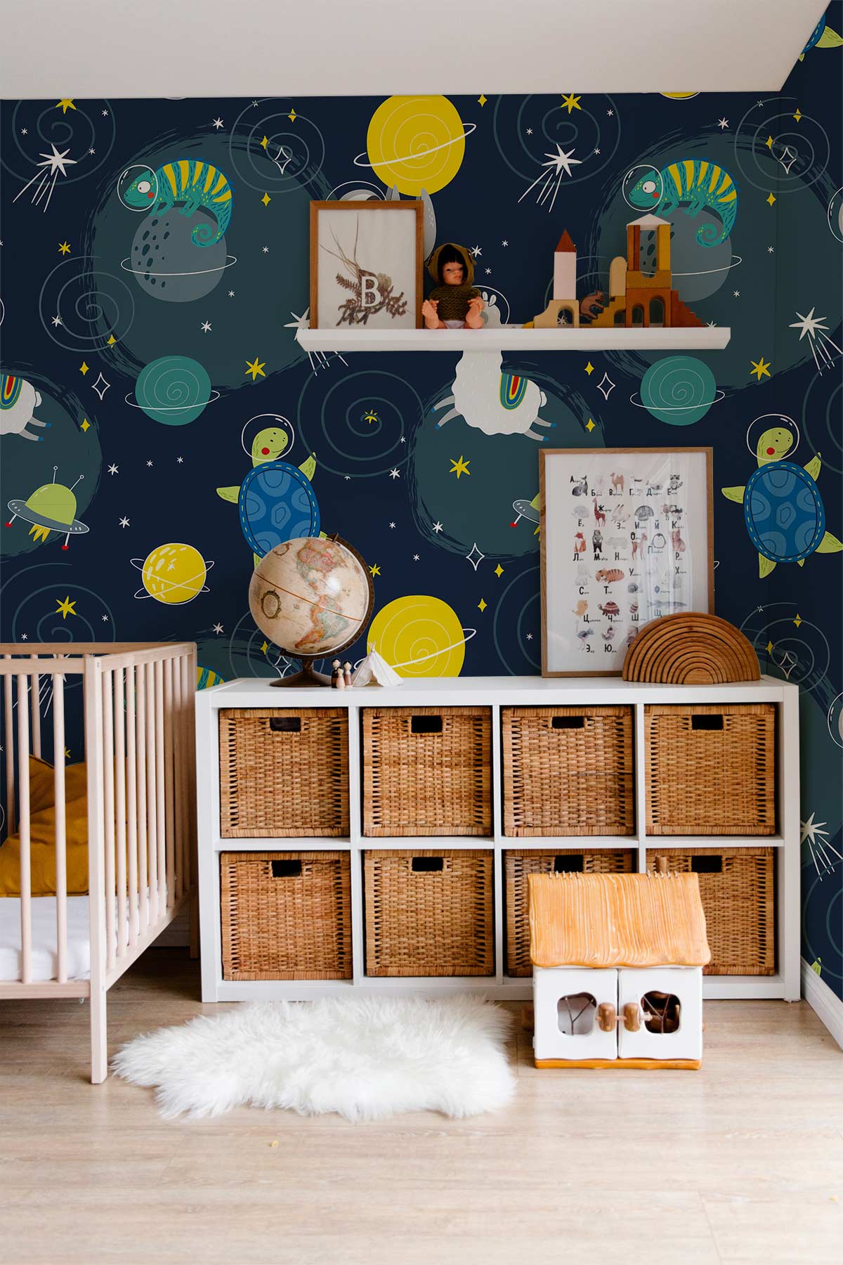 Kids room with Space Adventure Animals mural wallpaper, wicker storage, light wood floor, and white rug.