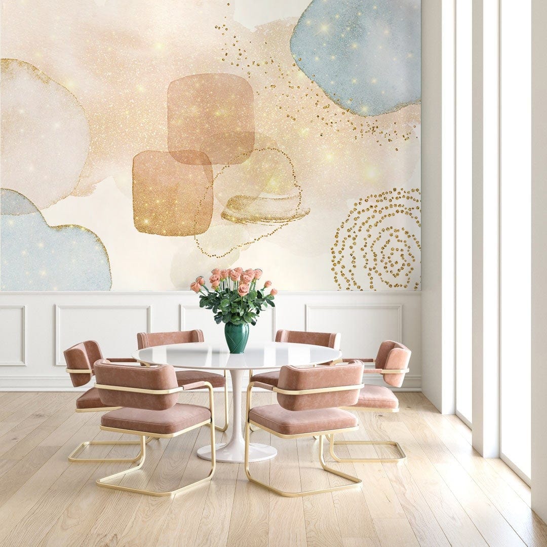Elegant pastel abstract mural wallpaper with gold glitter complements pink chairs and wood flooring in dining room.