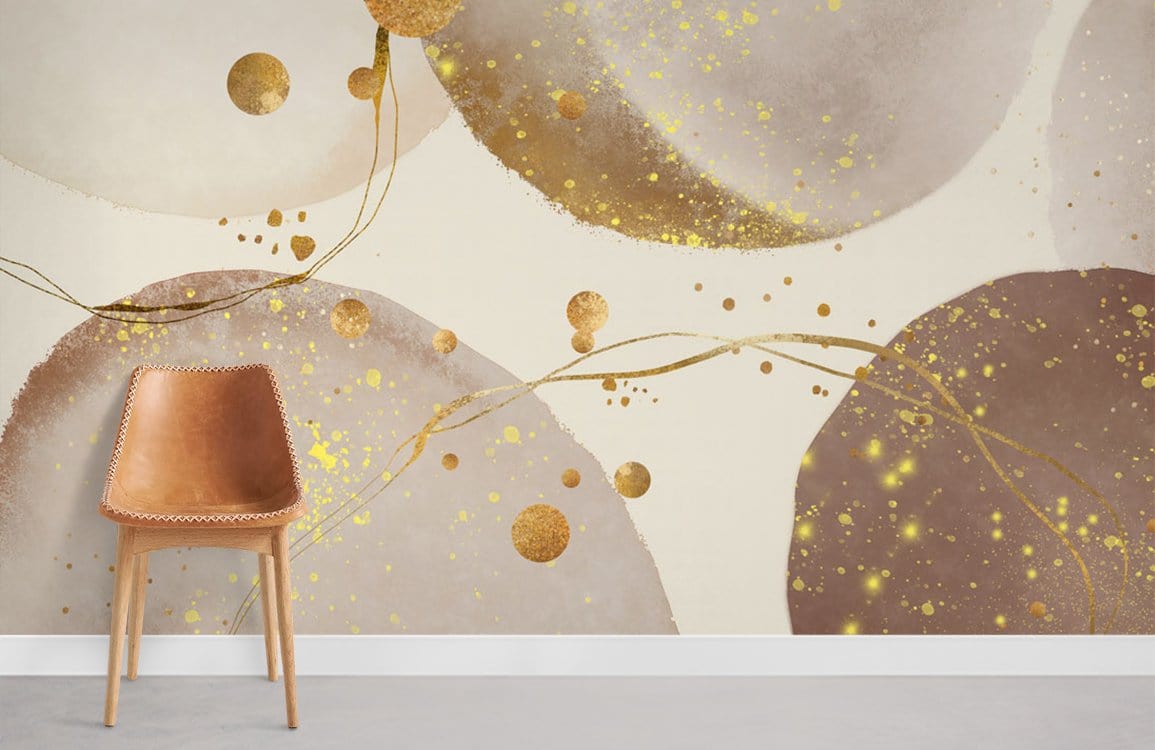 Luxe Metallic Abstract Wallpaper in cream with gold, bronze circles; wood chair, grey flooring, living room.