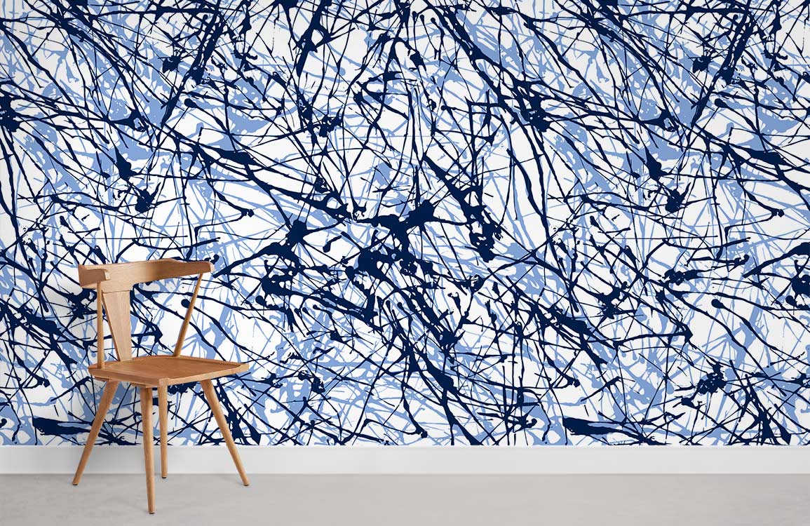 Contemporary art wallpaper with blue splatter pattern, wooden chair, and grey concrete flooring in modern room.