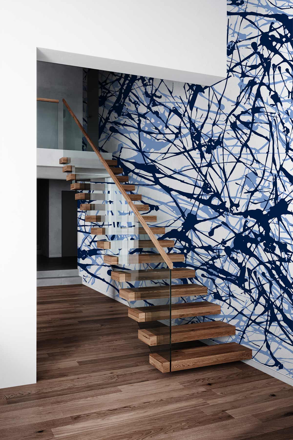 Abstract blue splatter wallpaper in modern hallway with floating wooden staircase and sleek glass railing.