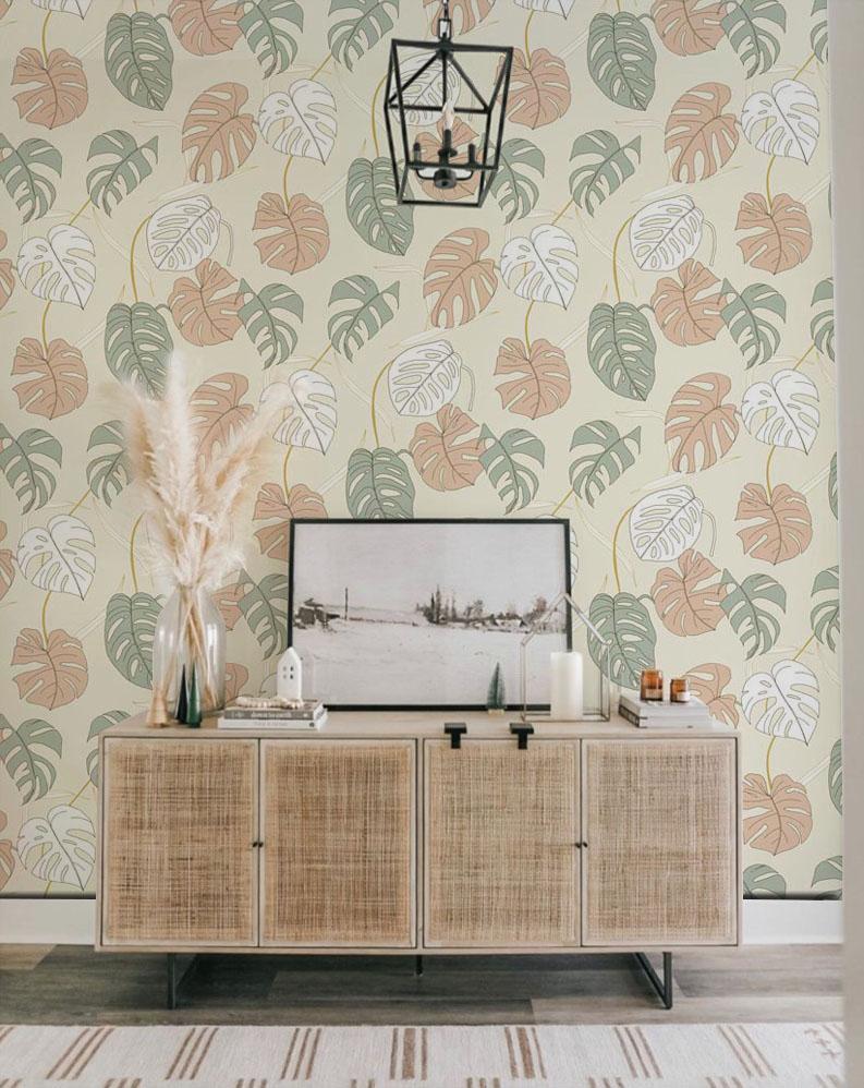 Tropical leaf wallpaper, pastel green and peach, natural wood sideboard, pendant light, modern living room.