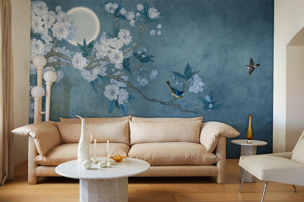 Blue floral birds mural wallpaper, beige sofa, marble table, wooden flooring, stylish living room decor.