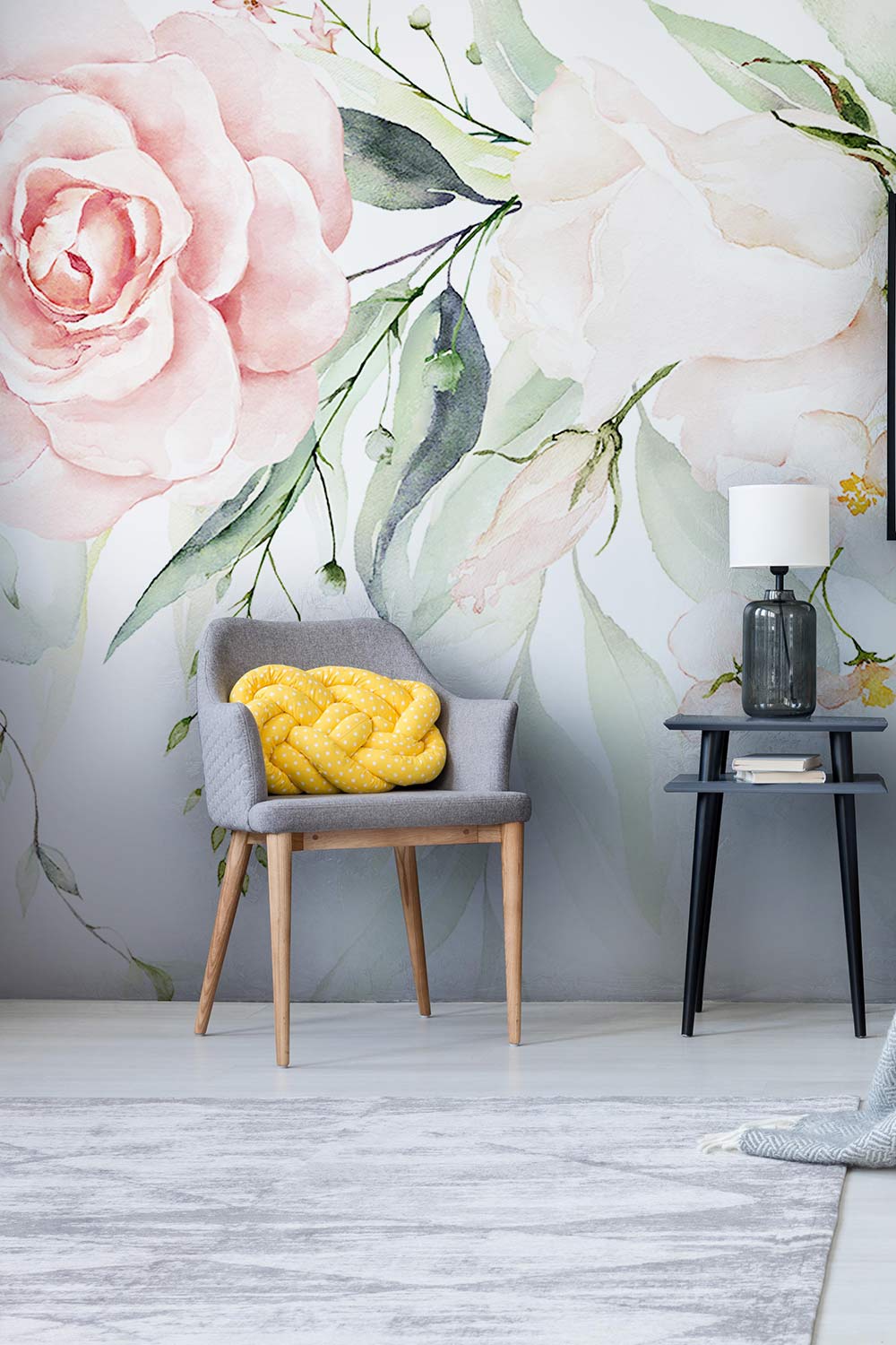 Romantic floral wallpaper with grey chair, textured rug, and modern black side table in living room.