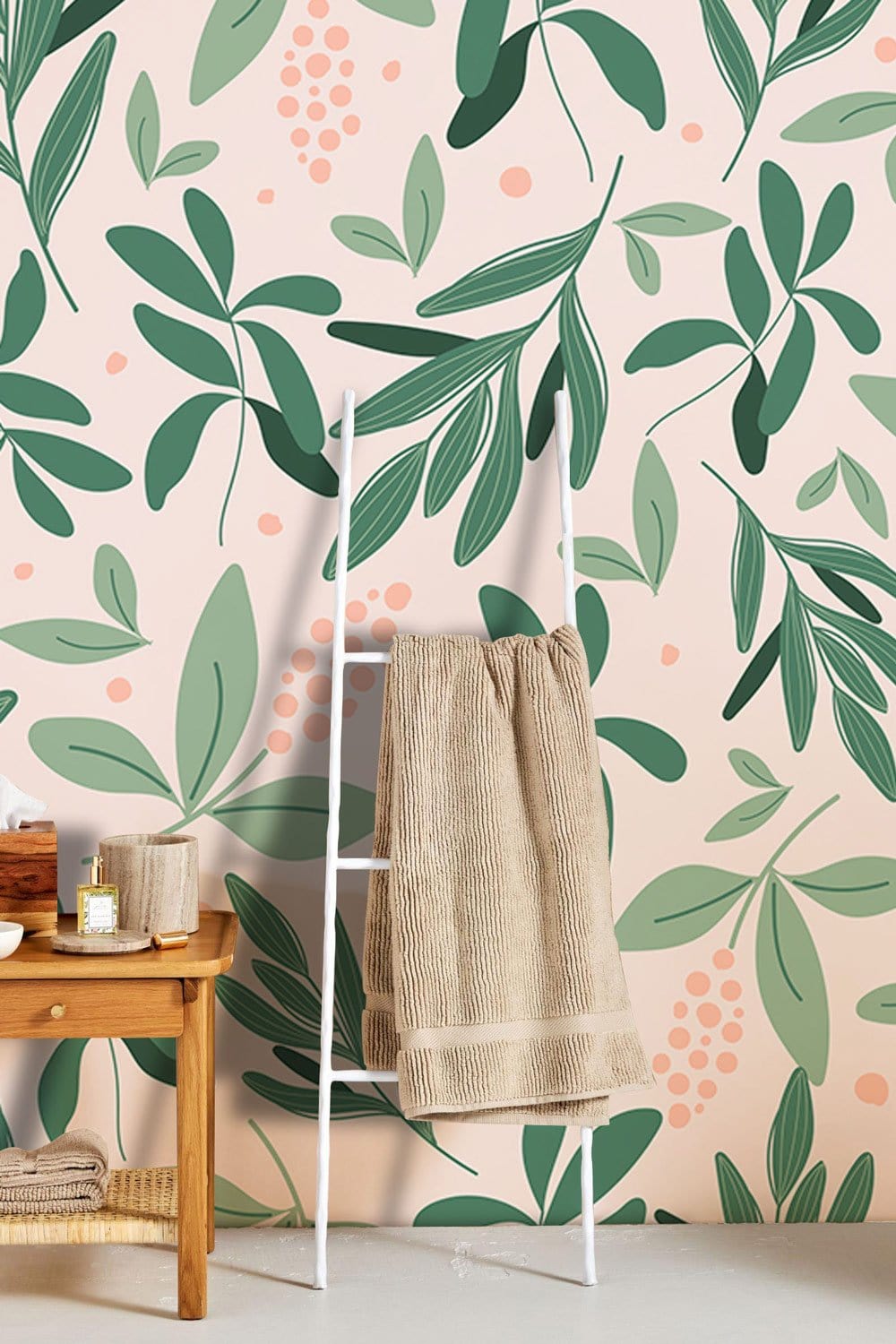 Organic green botanical wallpaper with leaf pattern, wooden table, beige towel ladder, modern interior design.