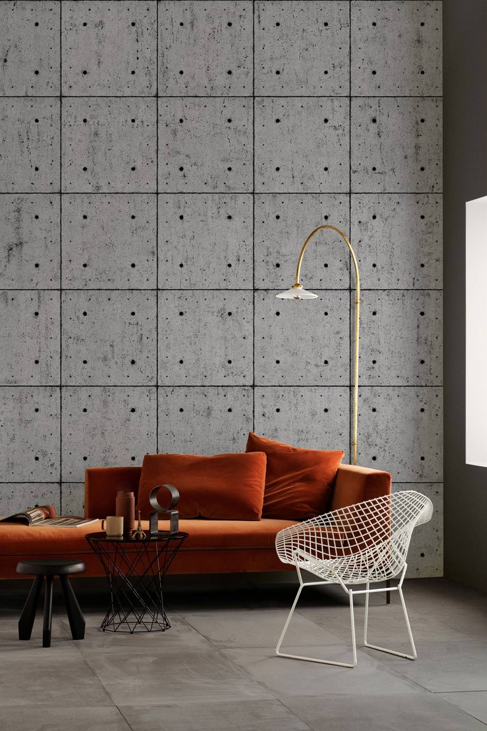 Industrial Grey Concrete Tile Effect Wallpaper in modern lounge with orange sofa and mesh chair.