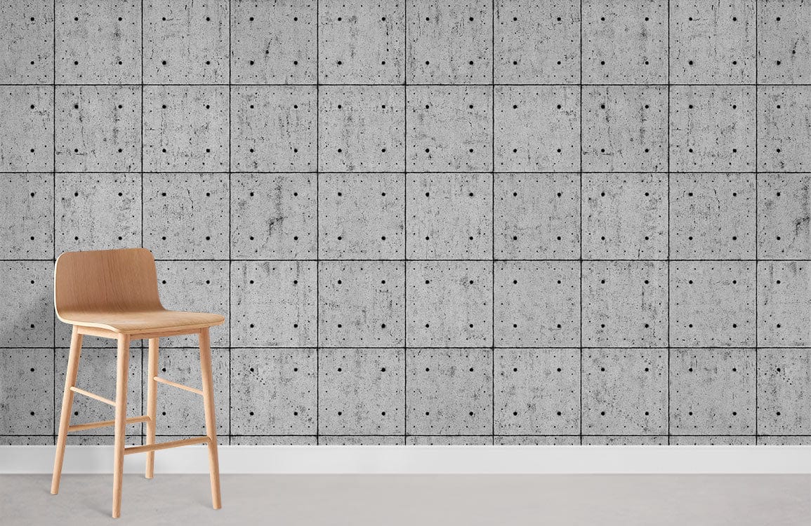 Modern industrial wallpaper with grey concrete tile effect, featuring a light wooden bar stool.