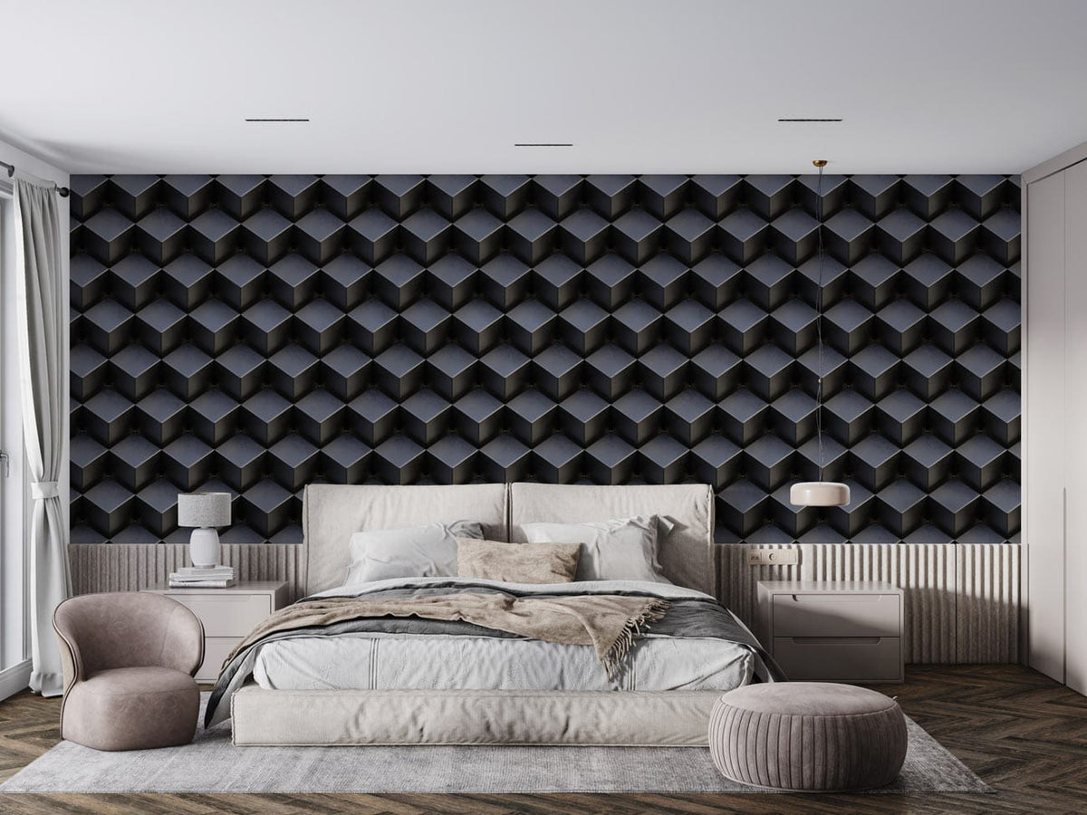 Modern geometric grey 3D hexagon wallpaper in bedroom with beige upholstered bed, plush chair, wooden flooring.