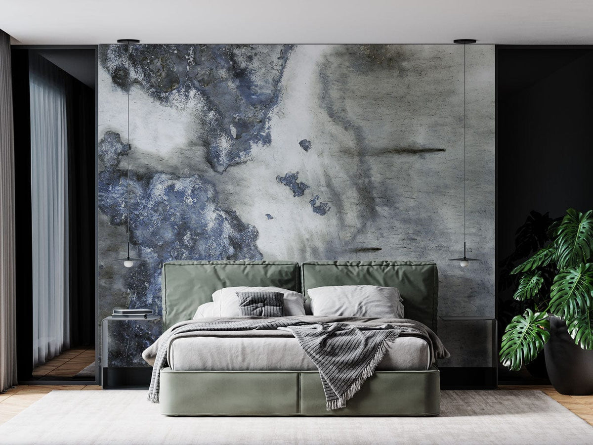 Elegant abstract marble wallpaper in bedroom with green bed, grey spread, wooden flooring, and hanging lights.