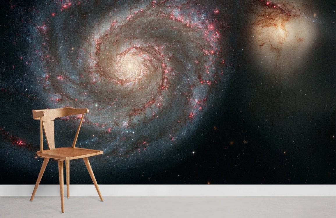 Galactic Spiral Galaxy Mural Wallpaper, cosmic blue design, wooden chair, minimalist flooring in living room.