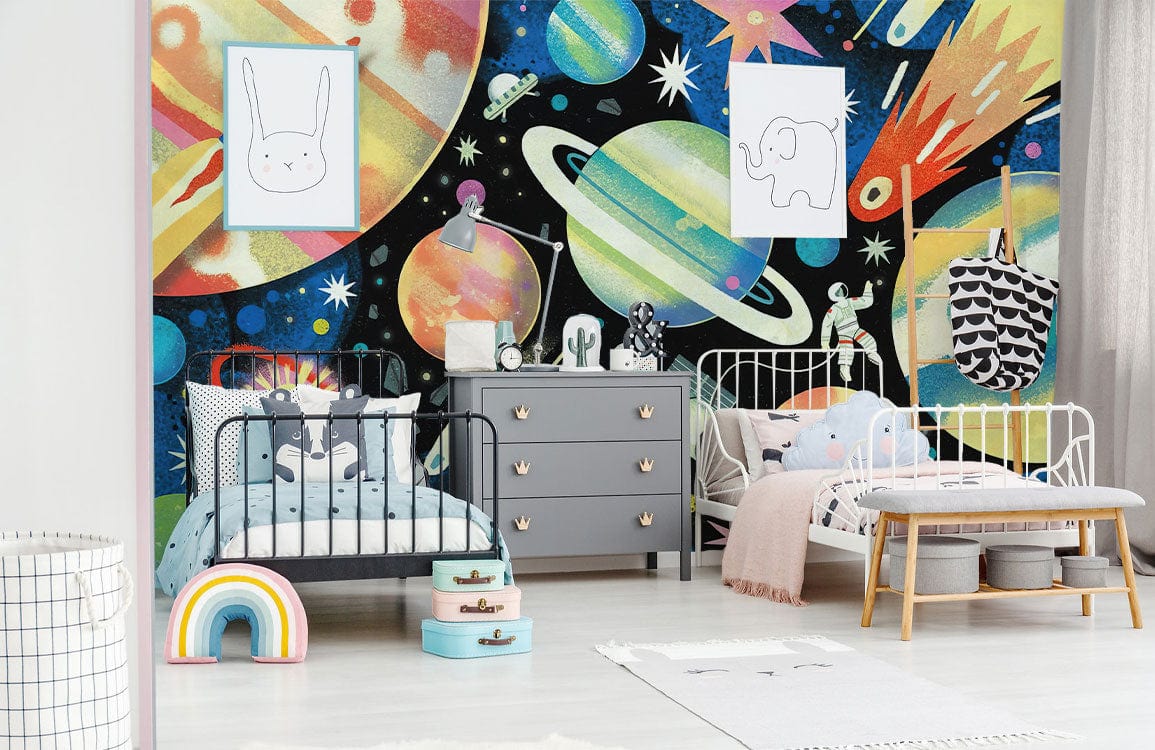 Children's room with space-themed wallpaper, grey dresser, colourful cosmic decor, light wooden flooring.