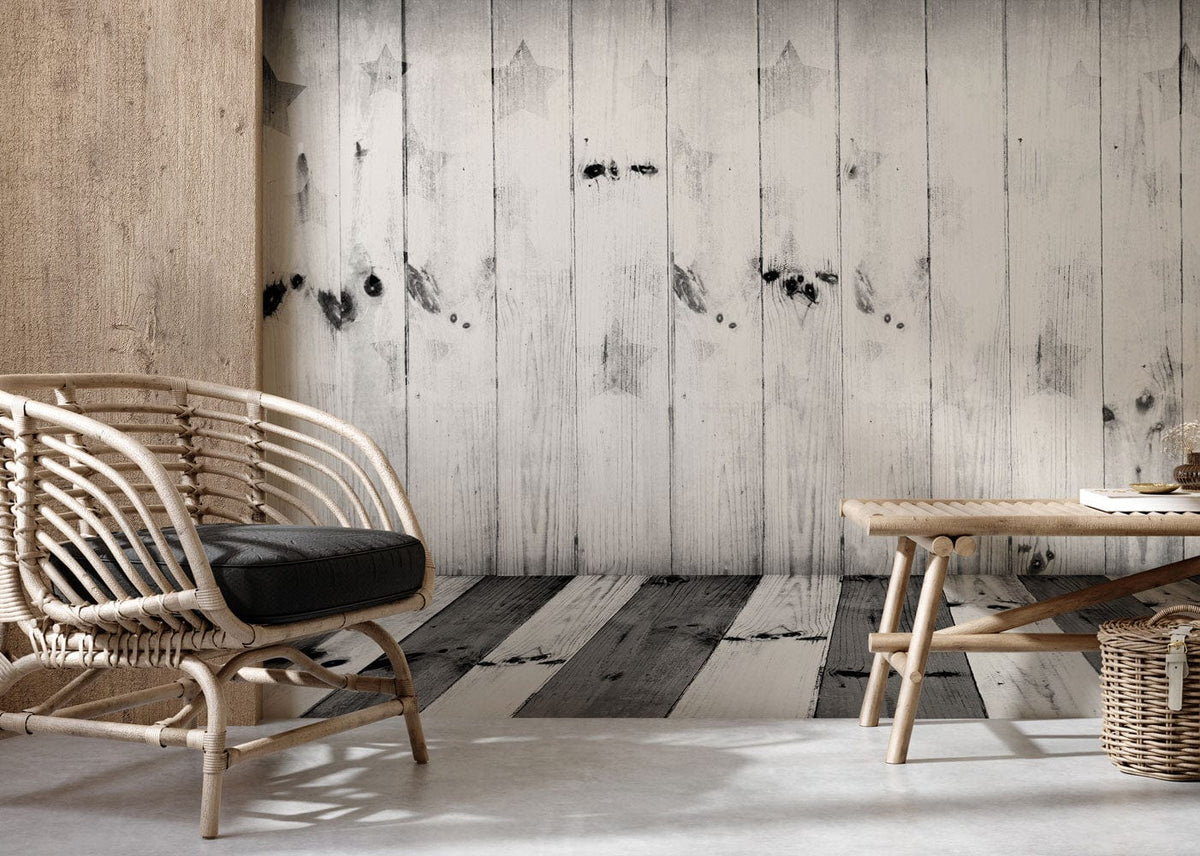 Rustic grey wood panel wallpaper with star pattern complements rattan chair, bench, in modern living room.