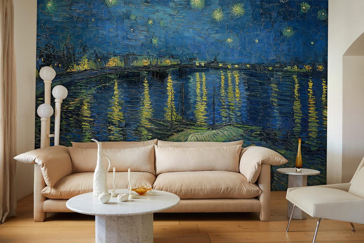 Tan sofa, marble coffee table, floor lamp; Starry Night mural wallpaper in blue and yellow hues.