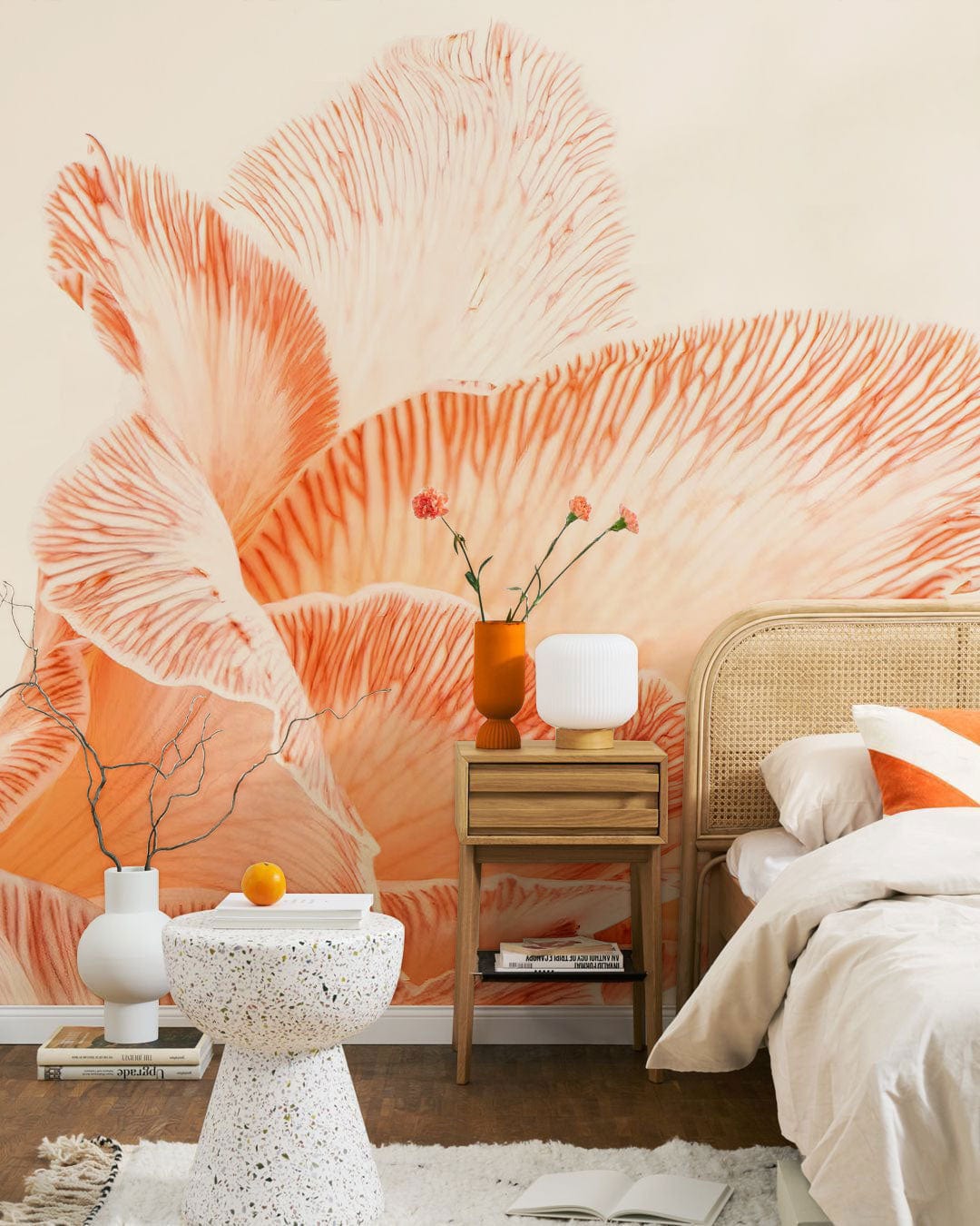 Elegant Peach Floral Blossom Wallpaper in bedroom with rattan headboard, textured side table, neutral bedding.