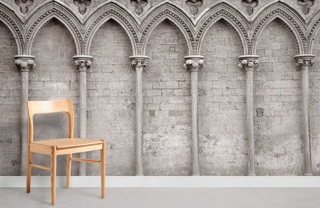 Vintage Gothic Archway Mural Wallpaper, sepia stone design, wooden chair, grey floor in living room.