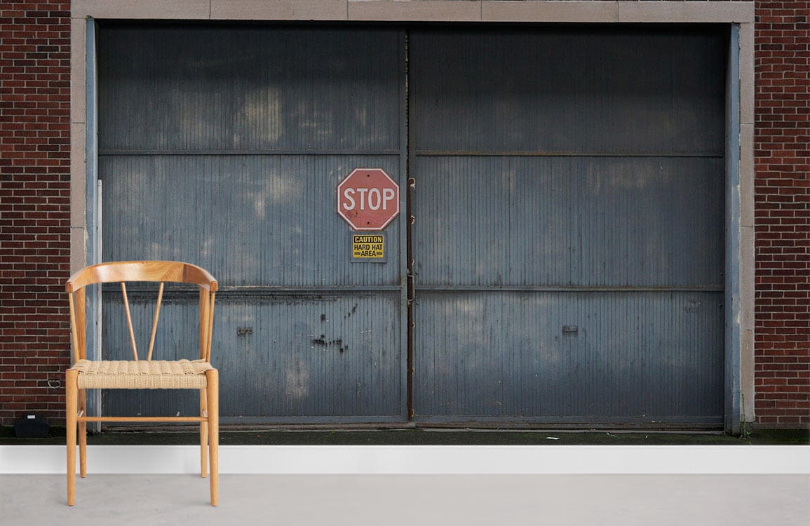 Industrial grey stop sign mural wallpaper with wooden chair, for modern urban room decor style.
