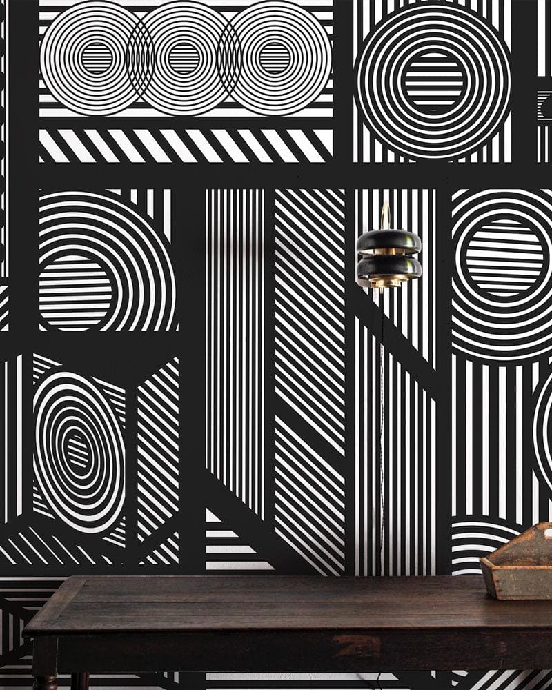 Monochrome geometric patterns wallpaper in modern living room with dark wooden table and industrial lamp.