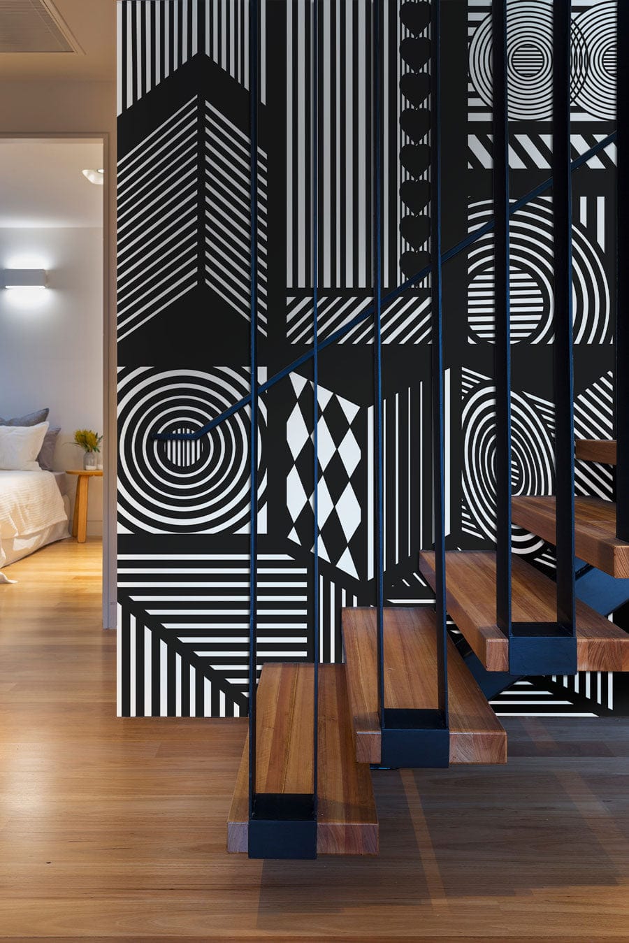 Monochrome geometric abstract wallpaper with wooden staircase, modern bedroom view, hardwood flooring.