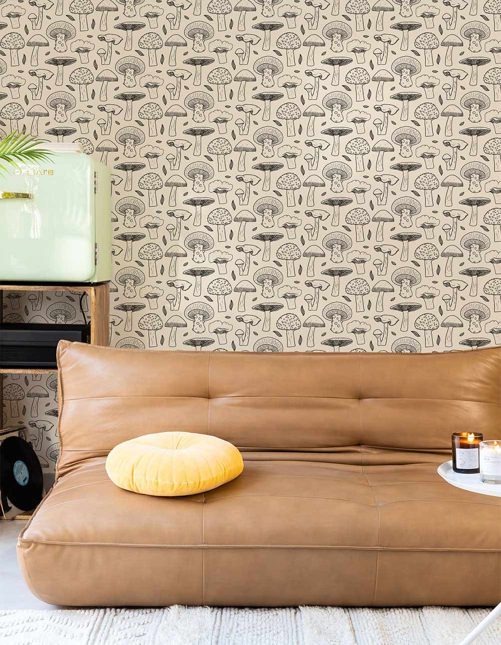 Whimsical beige mushroom wallpaper, vintage chic design, brown leather sofa, beige and light flooring.