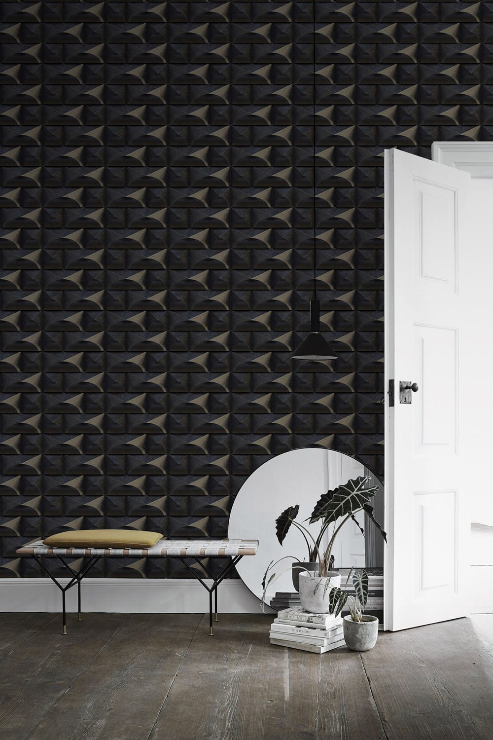Textured geometric charcoal black wallpaper with modern bench, round mirror, and white door in hallway.