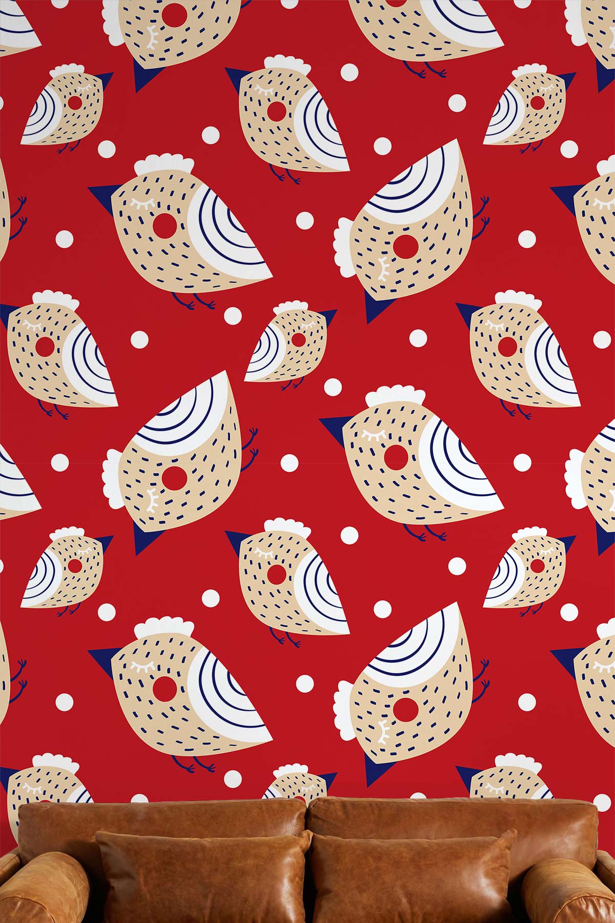 Red and beige whimsical bird wallpaper in living room with brown leather sofa, playful interior design.
