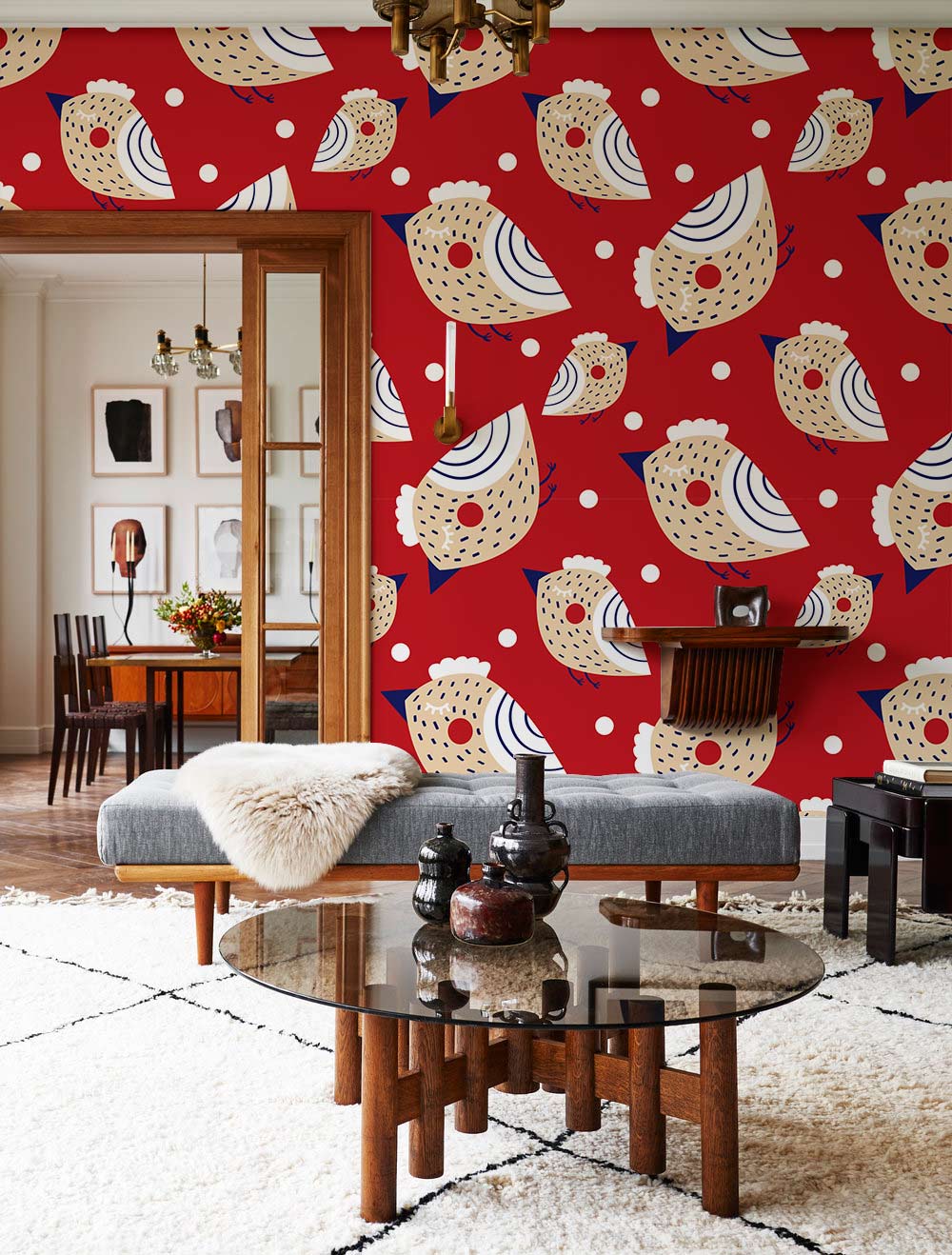 Red and Beige Whimsical Bird Pattern Wallpaper in a playful interior with grey bench, glass table, dining area.