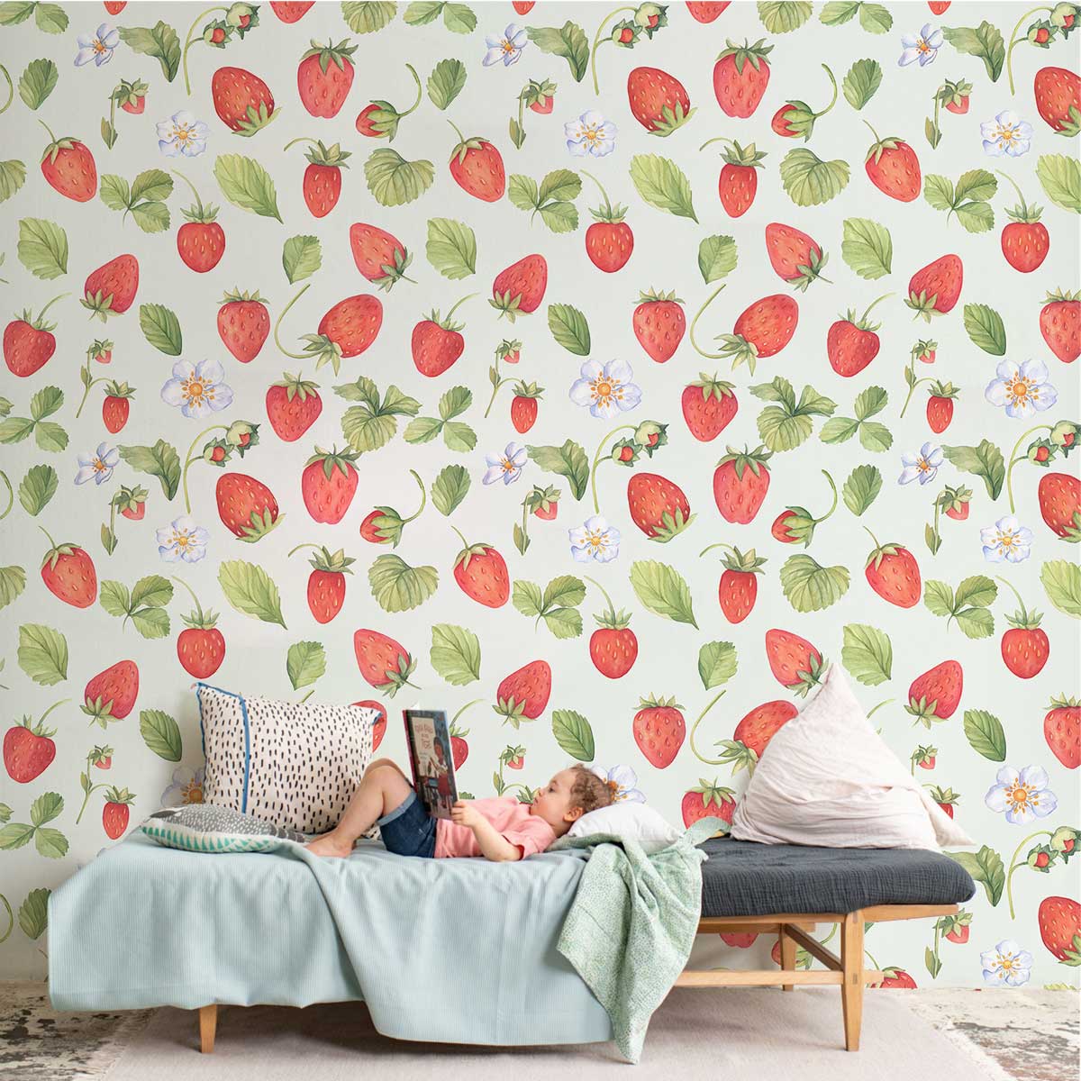Charming strawberry field wallpaper in watercolour pattern with cosy sofa, throw pillows, and soft rug.